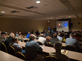 photo of a presentation in a darkened room