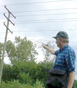 ARRL Lab's Mike Gruber, W1MG, hunting down a noise source